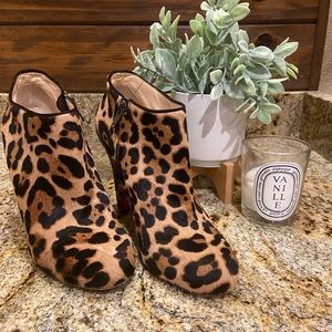 Louboutin calf hair ankle booties with demi-wedge and zip feature.